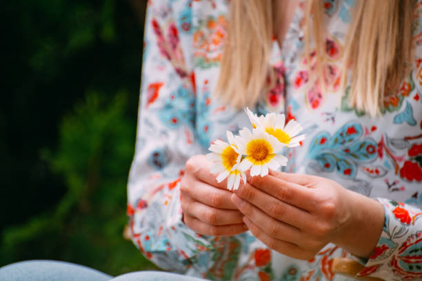 istock Woman Holding Daisies 1487254077