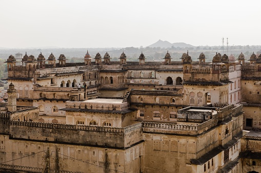 An aerial view of the historic Orchha Fort in India, with its intricate architecture and majestic walls