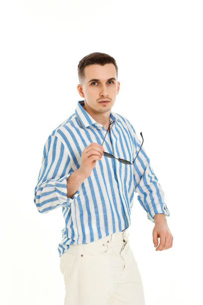 istock handsome young man in sunglasses and blue striped shirt 1487256852