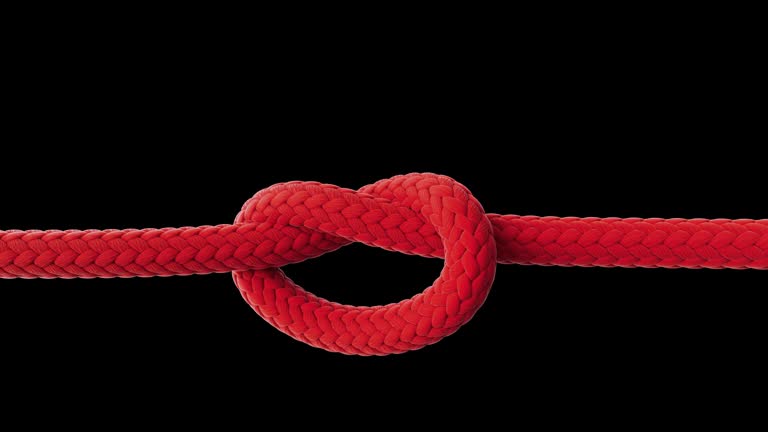 Red rope tightening in a knot