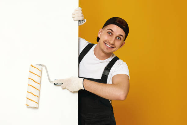 istock young man in working clothes painting white walls 1487257698