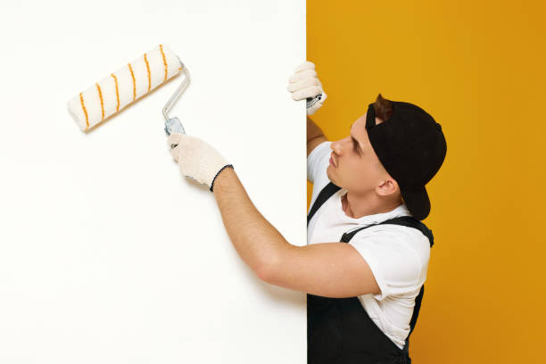 istock young man in working clothes painting white walls 1487257710