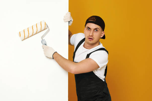istock young man in working clothes painting white walls 1487257715