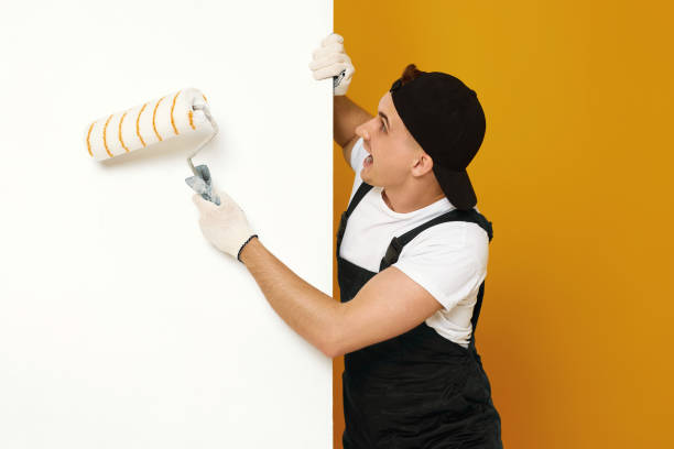 istock young man in working clothes painting white walls 1487257717
