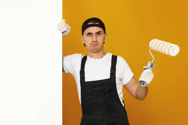 istock young man in working clothes painting white walls 1487257721