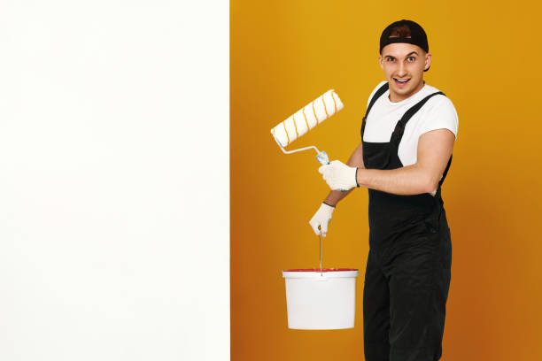 istock young man in working clothes painting white walls 1487257749