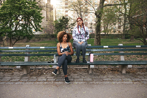 Portrait of two athletic women in a park.