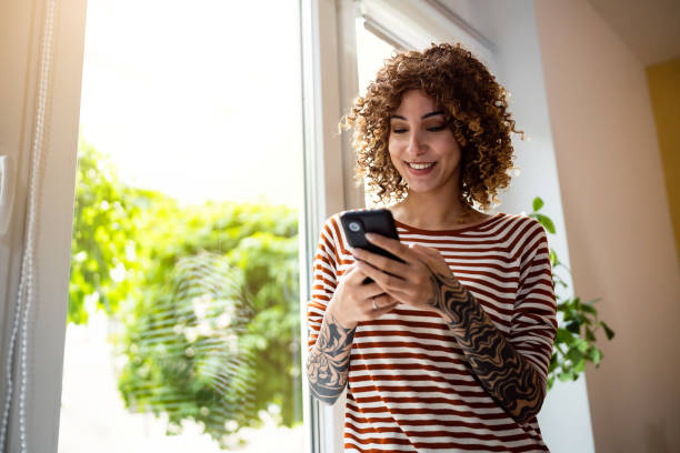 istock Young woman at home texting messages on her phone 1487263574