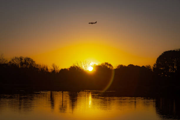 istock Dusk over a lake with a plane above 1487264197