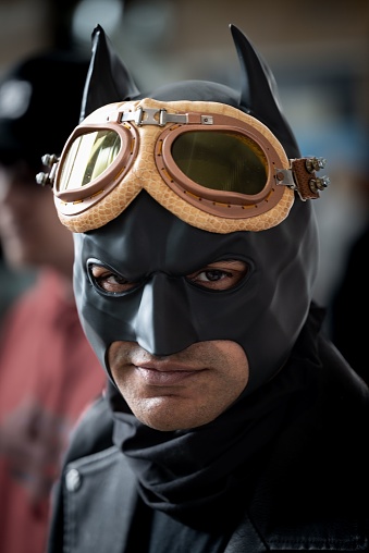Cape Town, South Africa – April 29, 2023: A man in a Batman mask is gazing to the left