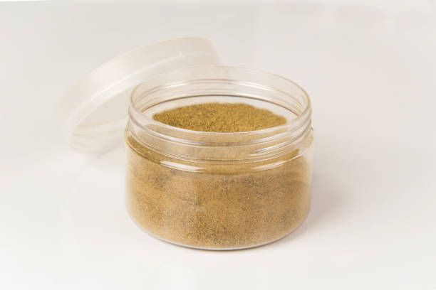plastic box full of black pepper on white background