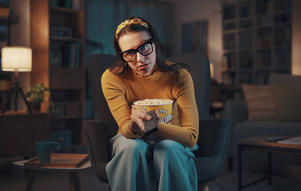 istock Bored woman watching TV at home 1487268195