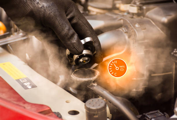istock Auto mechanic hand opens the radiator cap with steam escaping around the engine compartment from the high heat,water temp gauge symbol with high temperature. 1487269762