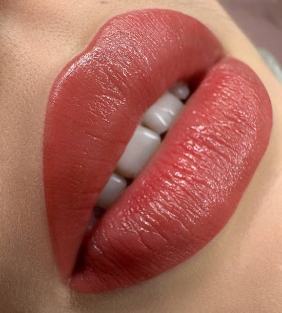 istock permanent sexy wowans lips tattoo close up, lipstick effect make up 1487271518
