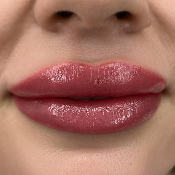 istock permanent sexy wowans lips tattoo close up, lipstick effect make up 1487271534