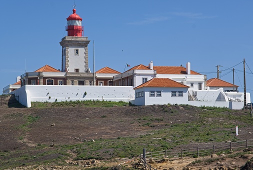 Colares, Portugal - April 2, 2023: Wonderful landscapes in Portugal. Scenic view from the Westernmost Point of Continental Europe (Cabo da Roca). Lighthouse, monument. Sunny spring day Selective focus