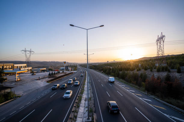 istock Flowing traffic on the highway at sunset 1487272167