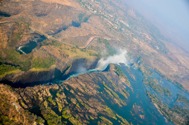View of the gorges or deep channels in the earth formed by the Zambezi Riverin Zimbabwe and Zambia. The white spray of Victoria Falls and the flow of the river is visible to the right. stock photo