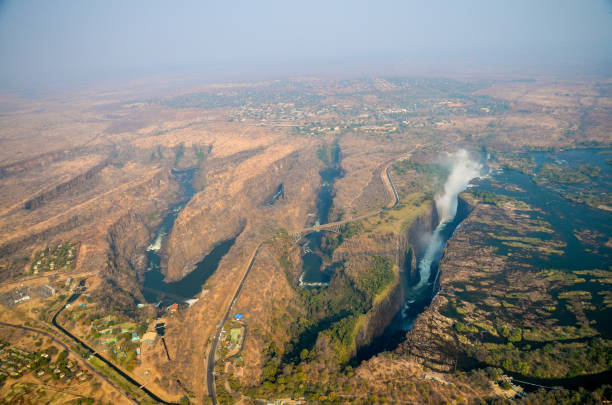 View of a series of gorges or deep channels in the earth formed by the Zambezi River in Zimbabwe and Zambia. The white spray of Victoria Falls waterfall is visible to the right stock photo