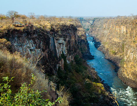 The famous Victoria Falls Bridge overlooks the activities of adventure tourists, such as white-water rafting, bungee jumps and ziplines. Photographed August 2013.