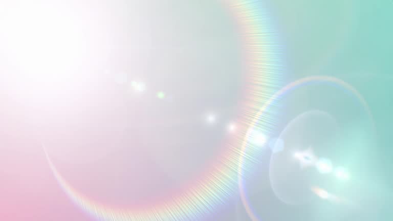 Bright spectrum lens flare on pale blue gradient