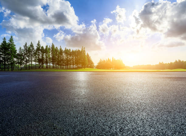 istock Asphalt road and forest with sky clouds at sunrise 1487272631