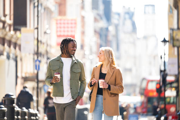 Couple on city break walking through Londons West End