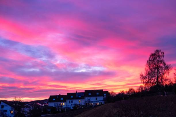 istock Beautiful Pink and Red Sundown over Fields and a small 1487275446