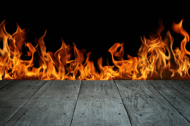 istock Old wood floor with flame on black background. 1487275909