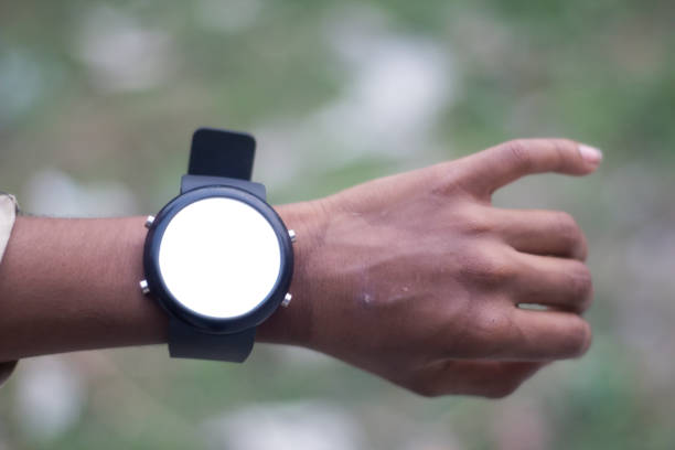 istock A watch in one hand and the background blurred behind 1487276930