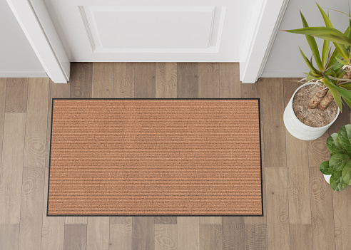 Blank brown door mat on the floor at home. Welcome mat with copy space for your text. Doormat mock up. Carpet at entrance for wiping dirty shoes. Mockup. 3D Rendering