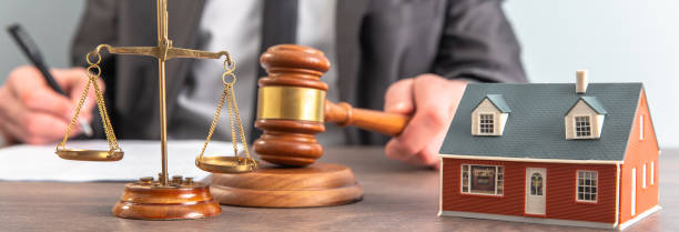 istock Lawyer hands holding judge and house model 1487277372