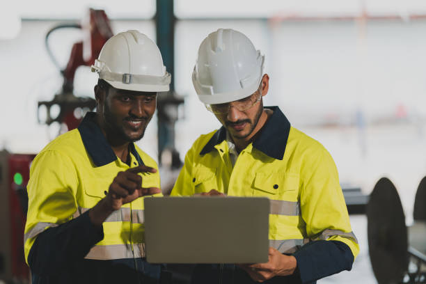 istock professional technician engineer with safety helmet hard hat working in industrial manufacturing factory, men at work to checking equipment of machinery production technology or construction operating 1487277531