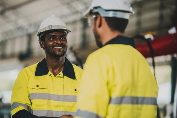 istock professional technician engineer with safety helmet hard hat working in industrial manufacturing factory, men at work to checking equipment of machinery production technology or construction operating 1487277570