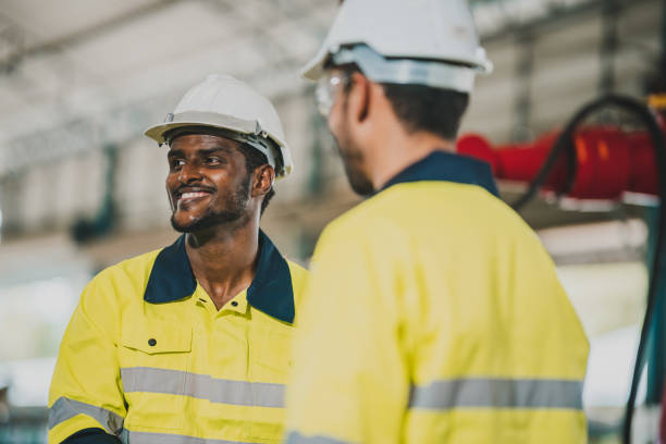 istock professional technician engineer with safety helmet hard hat working in industrial manufacturing factory, men at work to checking equipment of machinery production technology or construction operating 1487277634