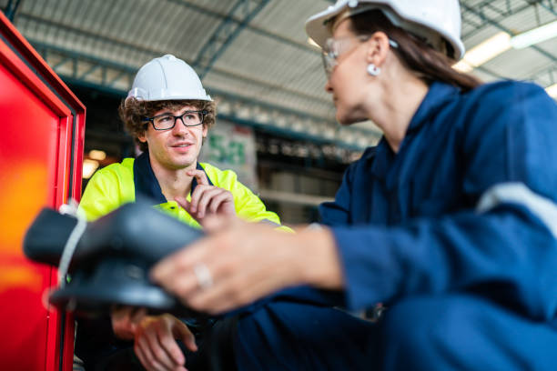 istock professional technician engineer with safety helmet hard hat working in industrial manufacturing factory, men at work to checking equipment of machinery production technology or construction operating 1487277725