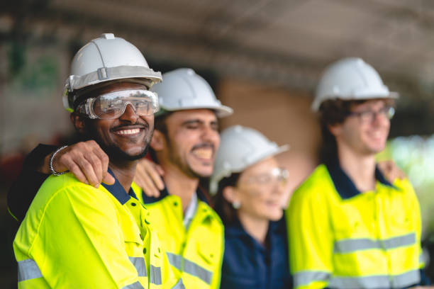 Professional industry engineer and factory foreman worker team person Wearing safety helmet hard hat, Technician people teamwork in work site of business construction and manufacturing technology job stock photo