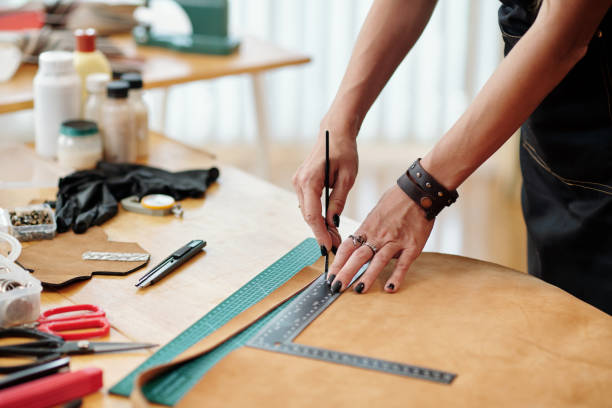istock Woman Cutting Leather Piece in Stripes 1487278740