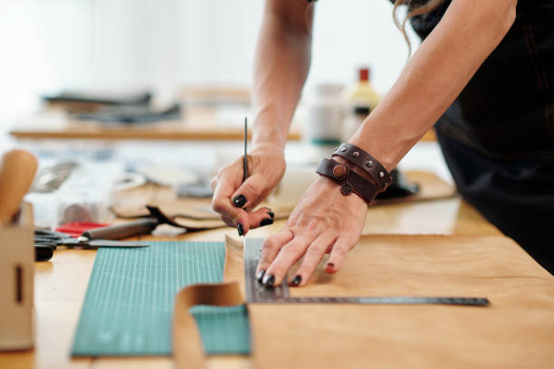 istock Woman Cutting Leather PIece in Stripes 1487278745