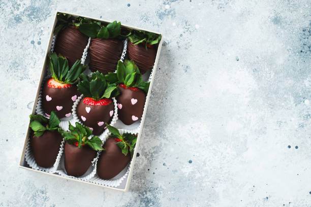 istock Gourmet chocolate covered strawberries on the light background. Top view with copy space. 1487279065