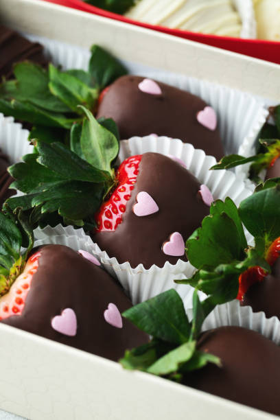 istock Gourmet chocolate covered strawberries on the light background. 1487279091