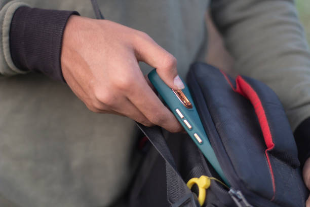 istock A boy is taking out a mobile phone from a bag and the background is blurred 1487279142