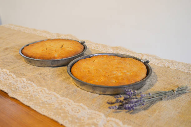 Two round sponge cakes in their tins - view from the side stock photo