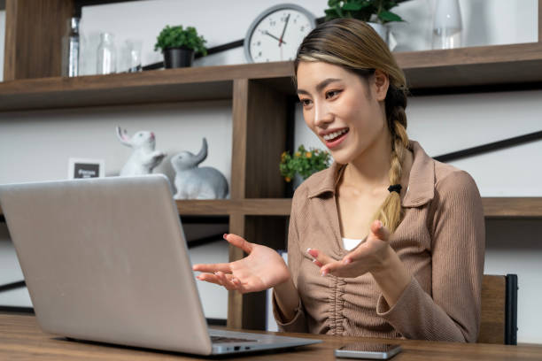 istock Young woman working on laptop computer at home 1487282447