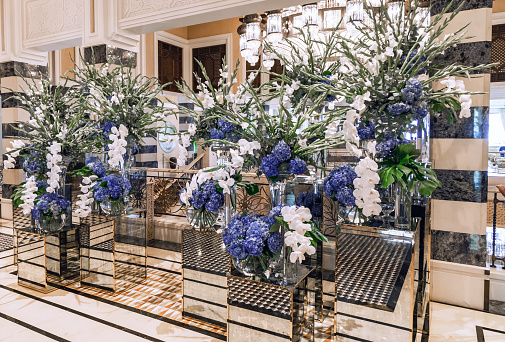 Large bouquets of hydrangeas and orchids in glass vases in the hotel lobby in Dubai.