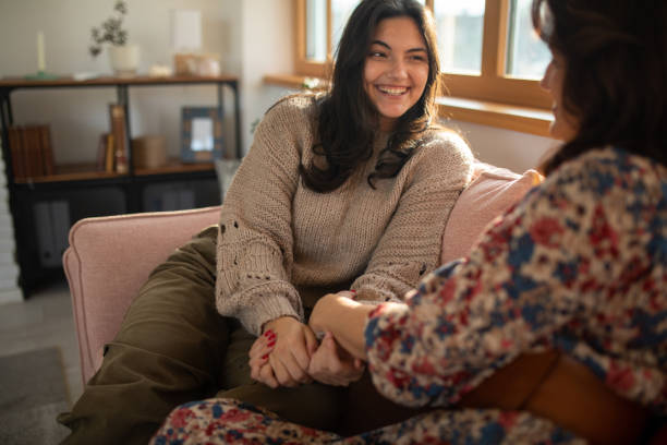 istock Mother and daughter talking on a living room sofa 1487283954