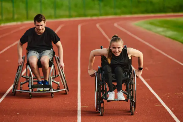 An inspiring couple with disability showcase their incredible determination and strength as they train together for the Paralympics pushing their wheelchairs in marathon track.