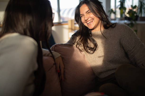 istock Two sisters talking to each other in a living room 1487284292