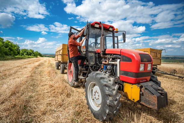 istock Farmer controlled harvest in his field and driving red tractor 1487285252