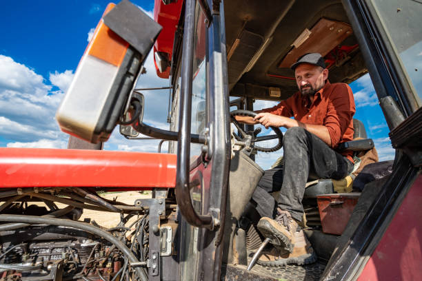 istock Farmer controlled harvest in his field and driving red tractor 1487285390